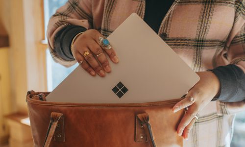 woman putting laptop in bag