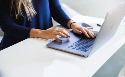 woman typing on laptop